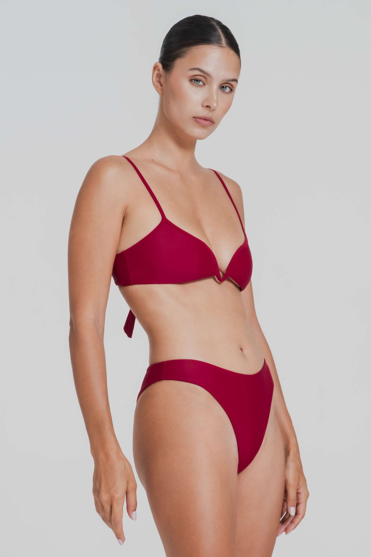 Woman wearing a red bikini against a plain background