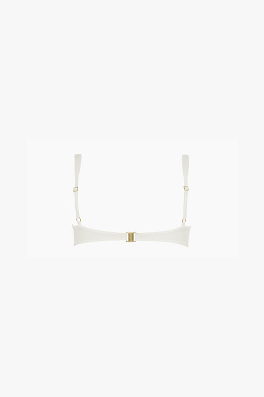 An off-white bikini top with a wide, curved band and thin shoulder straps, featuring a small gold metal closure at the center and gold rings at the strap attachments, set against a solid white background.