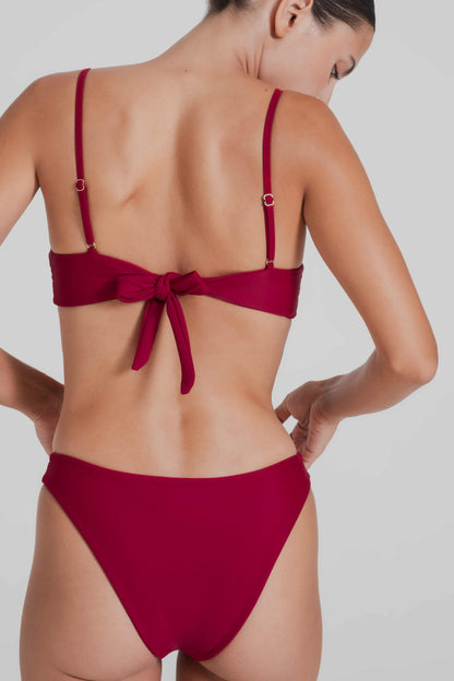 Red bikini worn by a model on a plain background