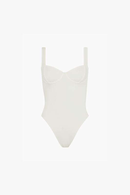 A light cream-colored one-piece swimsuit with a molded sweetheart neckline and thin shoulder straps, shown against a plain white background.