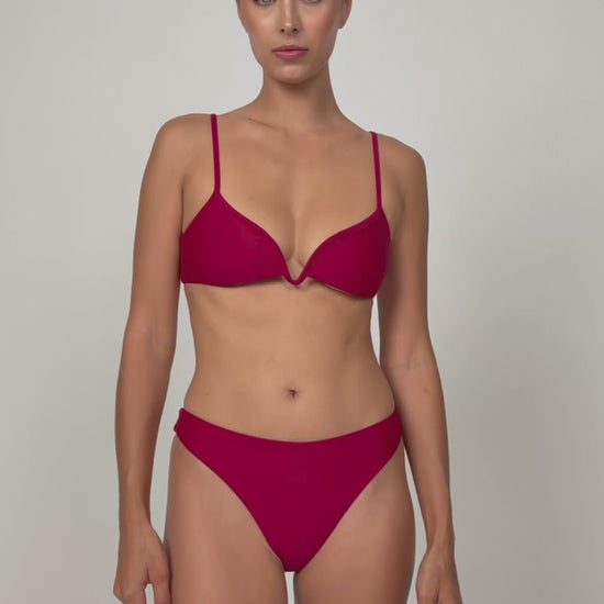 Woman wearing a red V plunge bikini