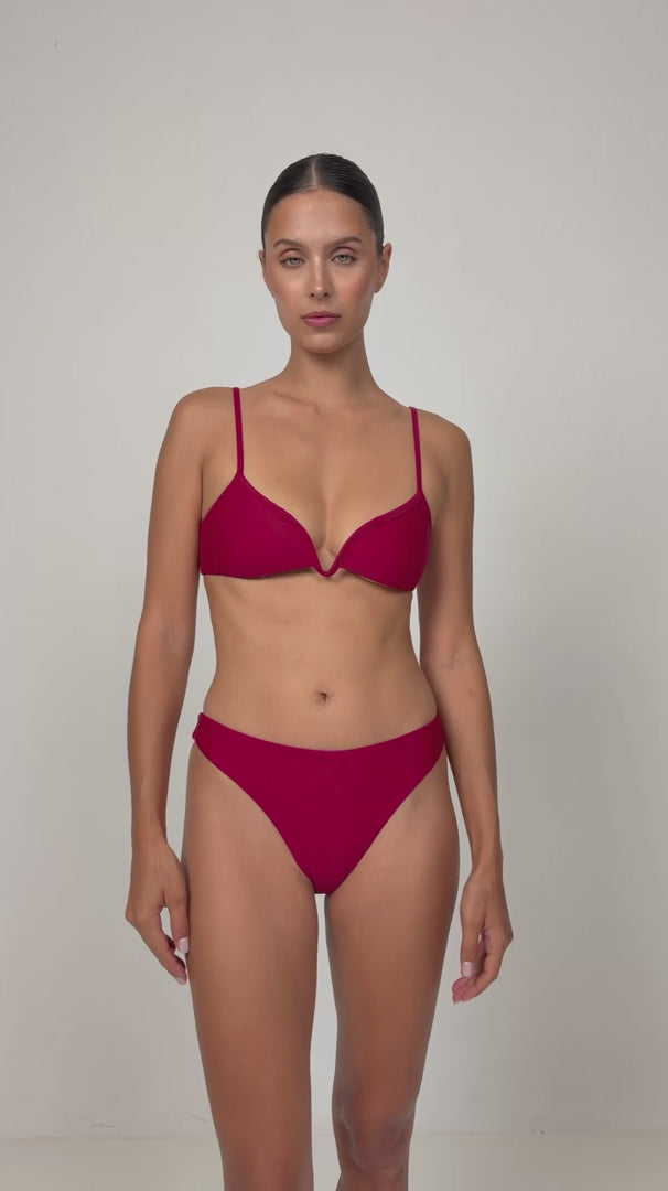 Woman wearing a red V plunge bikini